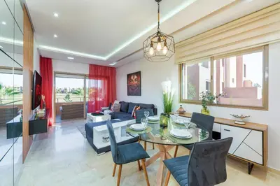 a living room with a table and a couch at Luxury Apartments Prestigia Pools Golf Fiber Parking in Marrakech