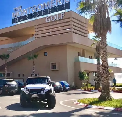 a white jeep parked in front of a building at Luxury Apartments Prestigia Pools Golf Fiber Parking in Marrakech