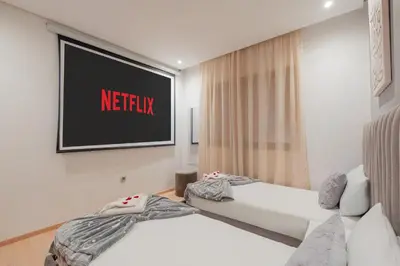 a hotel room with two beds and a television at Luxury Apartments Prestigia Pools Golf Fiber Parking in Marrakech