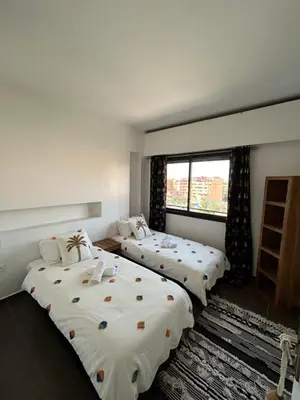 a bedroom with two beds and a window at Résidence Ghita La terrasse in Marrakech