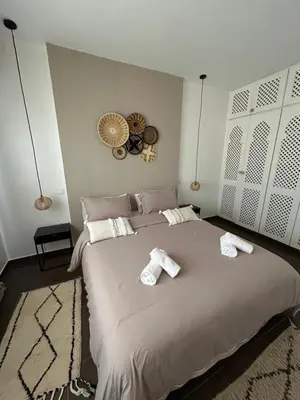 a bedroom with a large bed with two towels on it at Résidence Ghita La terrasse in Marrakech
