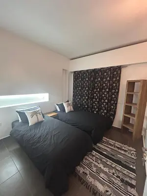 a bedroom with two beds and a wall at Résidence Ghita La terrasse in Marrakech
