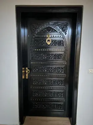 a black door with an ornate design on it at Résidence Ghita La terrasse in Marrakech