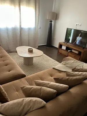 a living room with a couch and a tv at Résidence Ghita La terrasse in Marrakech