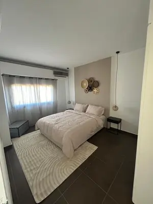 a bedroom with a large bed and a fan at Résidence Ghita La terrasse in Marrakech