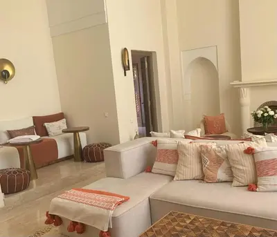 a living room with a couch and a table at Villa Magnolia - Amelkis Golf in Marrakech