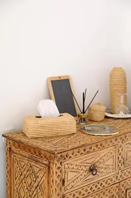 a wooden dresser with a picture on top of it at Riad Al Badia in Marrakech