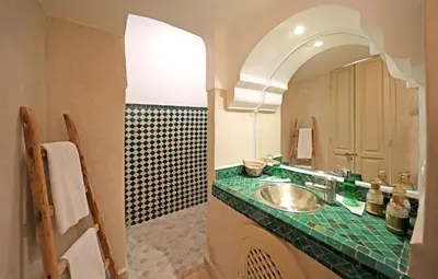 a bathroom with a sink and a mirror at Riad Al Badia in Marrakech