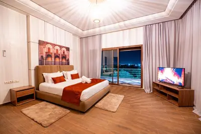 a bedroom with a bed and a flat screen tv at Konouz Palace in Marrakech