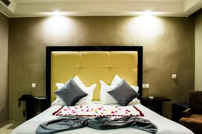 a bedroom with a large bed with pillows at Tempoo Hotel Marrakech City Centre Adults Only in Marrakech