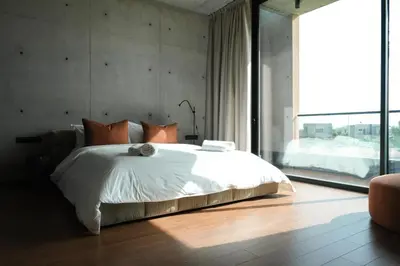 a bedroom with a white bed and a large window at VIP villa in Marrakech