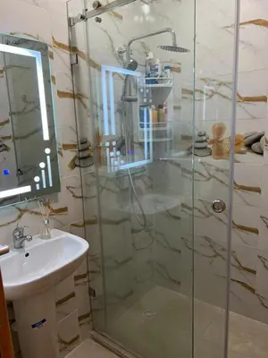 a bathroom with a shower and a sink at Propre appartement à loué pour les familles in Marrakech