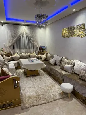 a living room with a large couch and a table at Propre appartement à loué pour les familles in Marrakech