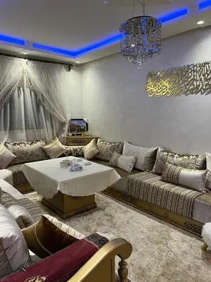 a living room with a couch and a table at Propre appartement à loué pour les familles in Marrakech