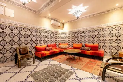 a living room with a red couch and a table at Riad Dali in Marrakech