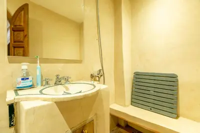 a bathroom with a sink and a mirror at Riad Dali in Marrakech