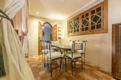 a dining room with a table and chairs at Riad Dali in Marrakech