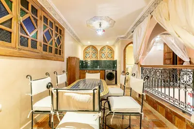a dining room with chairs and a table at Riad Dali in Marrakech