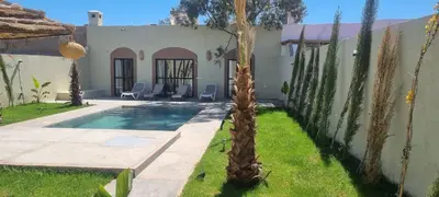 a villa with a swimming pool and a house at Villa BALI KECH in Marrakech
