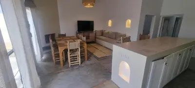 a kitchen and living room with a table and a couch at Villa BALI KECH in Marrakech