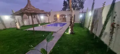a backyard of a house with a swimming pool at Villa BALI KECH in Marrakech