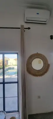a room with a window and a fan and a door at Villa BALI KECH in Marrakech