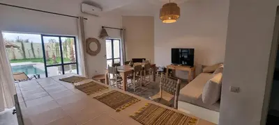 a living room with a couch and a dining room at Villa BALI KECH in Marrakech