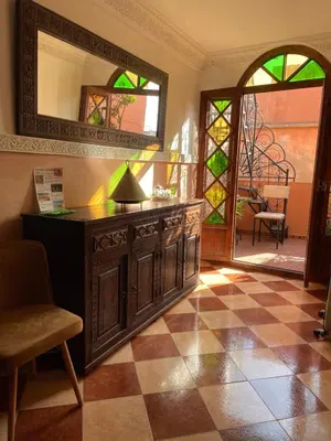 a room with a dresser and a mirror and a floor at Dar Dadès in Marrakech