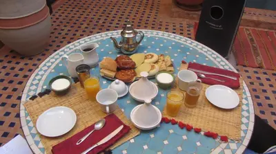 a table with a plate of breakfast food on it at Riad Hadda in Marrakech
