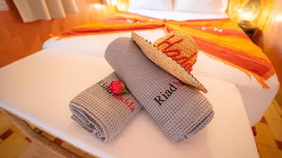a pair of socks and a hat on a bed at Riad Hadda in Marrakech