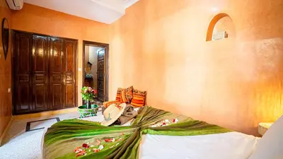 a bedroom with a bed with a blanket on it at Riad Hadda in Marrakech