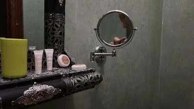 a bathroom with a mirror and a counter with cosmetics at Riad khoya magnifique in Marrakech