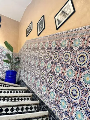 a set of stairs with a tile wall at Riad khoya magnifique in Marrakech