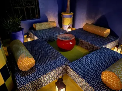 a group of tables with a vase sitting on top at Riad khoya magnifique in Marrakech