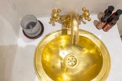 a gold sink with a faucet on a counter at Luxe Nomade Marrakech & Spa in Marrakech