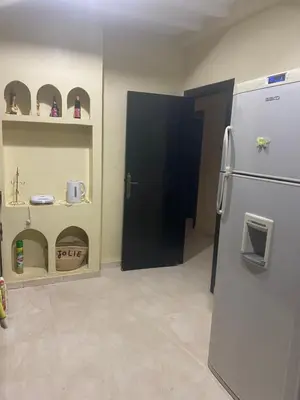 a kitchen with a refrigerator and a police door at Charm & Chic Résidence in Marrakech
