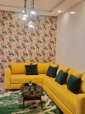 a living room with a yellow couch and a table at Studio Cosy au Centre de Marrakech - Guéliz - in Marrakech