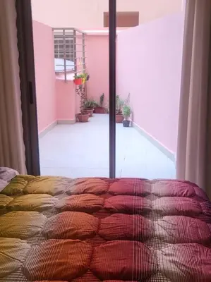 a bed in a room with a large window at Studio Cosy au Centre de Marrakech - Guéliz - in Marrakech