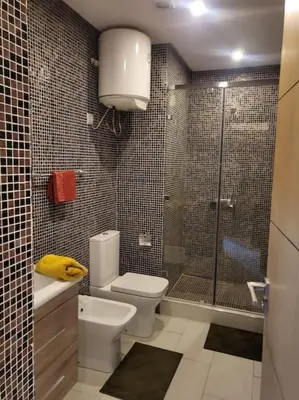a bathroom with a shower and a toilet and a sink at Studio Cosy au Centre de Marrakech - Guéliz - in Marrakech
