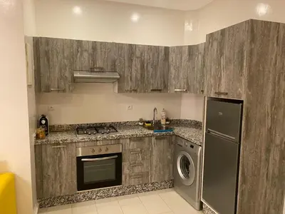a kitchen with a stove and a washer and dryer at Studio Cosy au Centre de Marrakech - Guéliz - in Marrakech