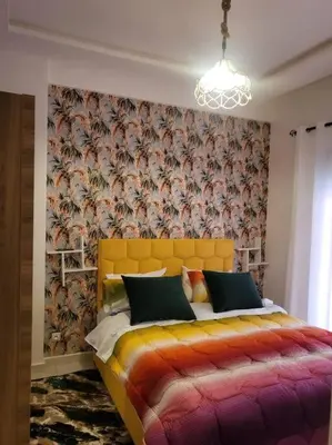 a bedroom with a yellow bed with a wallpaper at Studio Cosy au Centre de Marrakech - Guéliz - in Marrakech