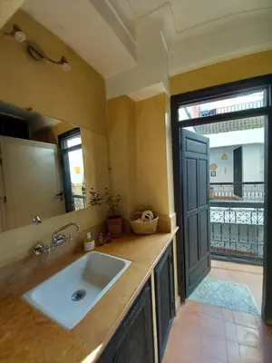a bathroom with a sink and a large mirror at Riad Hostel JAD ZIAD in Marrakech
