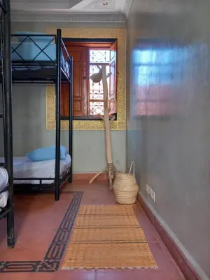 a room with two bunk beds and a window at Riad Hostel JAD ZIAD in Marrakech