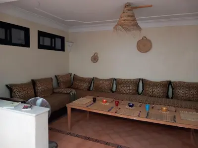 a living room with a couch and a table at Riad Hostel JAD ZIAD in Marrakech