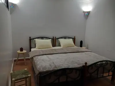 a bedroom with a large bed with two pillows at Riad Hostel JAD ZIAD in Marrakech
