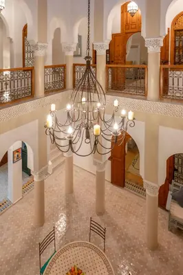 a large room with a chandelier in a building at Riad Dar Azal in Marrakech