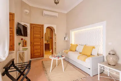 a living room with a white couch and a table at Riad Dar Azal in Marrakech