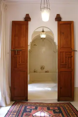 an entrance to a room with a door and a rug at Riad El Morocco Hotel in Marrakech