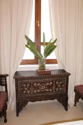 a potted plant sitting on a table in front of a window at Riad El Morocco Hotel in Marrakech