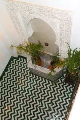 a room with potted plants and a white ceiling at Riad El Morocco Hotel in Marrakech